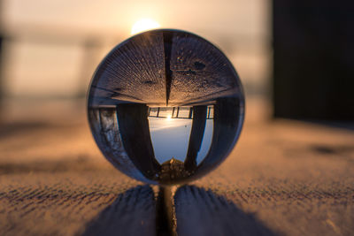 Crystal ball on hardwood floor during sunset