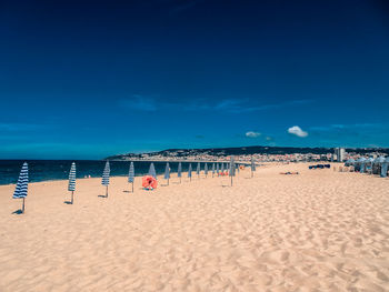 Scenic view of beach against blue sky