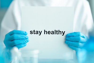 Close-up of human hand with text