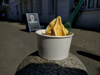 Close-up of ice cream cup on stone