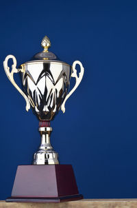 Close-up of trophy against blue wall