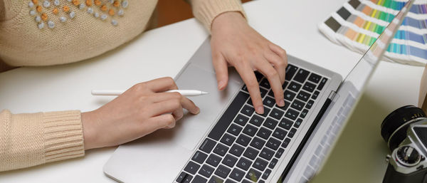 Midsection of woman working at desk