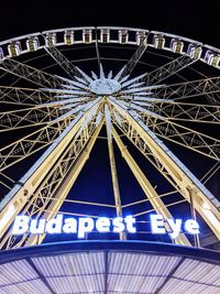Low angle view of illuminated ferris wheel at night