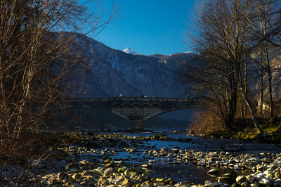 Bridge over river with mountain in background
