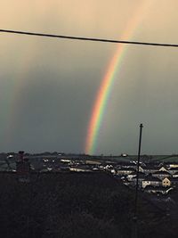 Scenic view of rainbow over dramatic sky