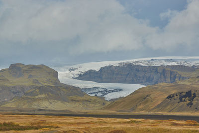 Scenic view of landscape and mountains against sky