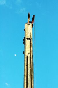 Low angle view of pole against clear blue sky