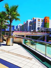 View of swimming pool by buildings against sky