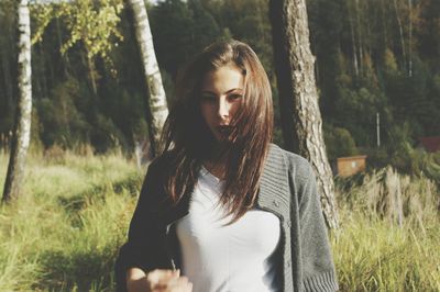 Beautiful young woman in tree trunk