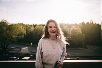 Portrait of smiling mid adult man standing against sky