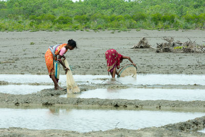 Side view of man with umbrella on land