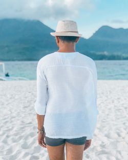 Rear view of man standing on beach