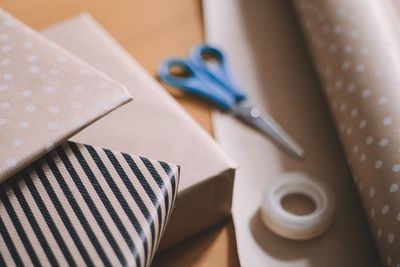 Close-up of gift boxes with scissor