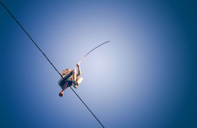 Low angle view of statue against clear blue sky