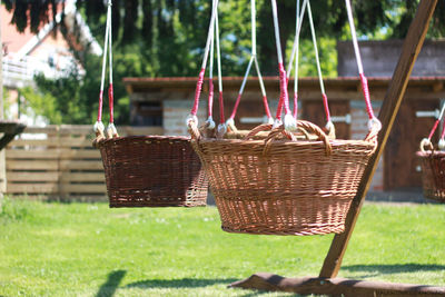 Empty swing hanging in basket on field