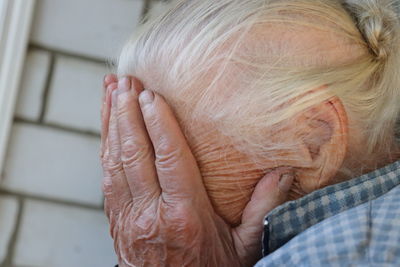 Close-up of woman covering face