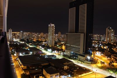 Illuminated cityscape against sky at night