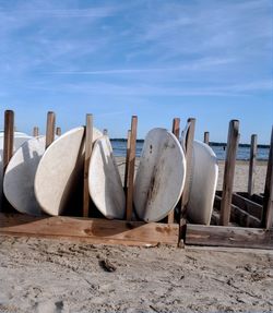 Panoramic view of beach umbrellas on field against sky