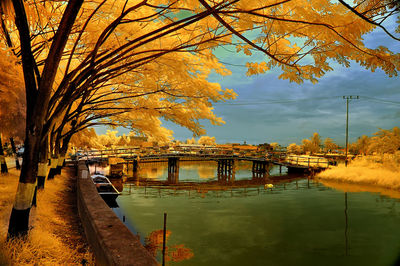 Bridge over river against sky during autumn