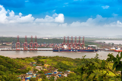 Commercial dock by sea against sky