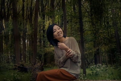 Young woman smiling in forest