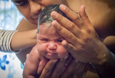 Parents bathing baby boy