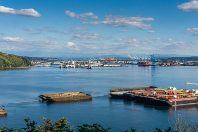 Mount rainier is partially hidden by clouds at the port of tacoma.