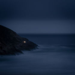 Scenic view of sea against clear sky at night