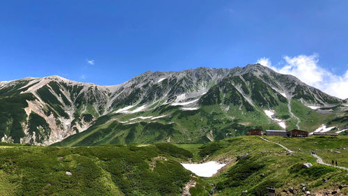 Scenic view of mountains against blue sky