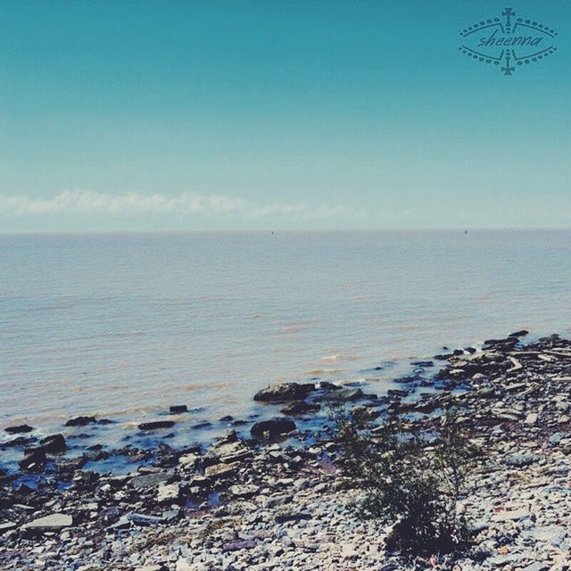 sea, water, horizon over water, tranquil scene, scenics, tranquility, beach, beauty in nature, blue, shore, clear sky, nature, rock - object, copy space, sky, idyllic, calm, coastline, seascape, outdoors