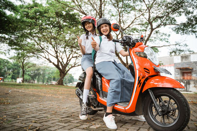 Man riding motor scooter on road