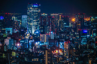 Illuminated modern buildings in city at night