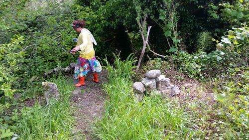 Rear view of girl working on plants