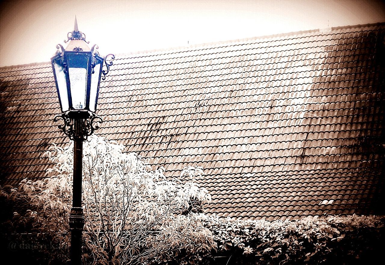 architecture, building exterior, built structure, lighting equipment, street light, low angle view, protection, brick wall, wall - building feature, security, safety, sky, no people, outdoors, building, metal, day, house, electricity, electric light