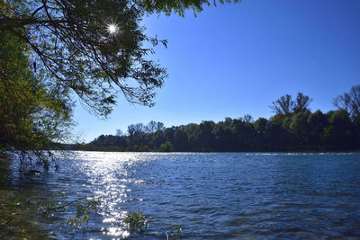 Scenic view of lake against clear blue sky