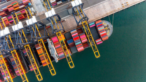 Container ship loading and unloading at deep sea port, aerial view  global business logistic import