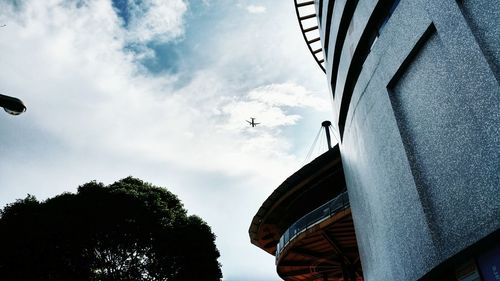 Low angle view of building against cloudy sky