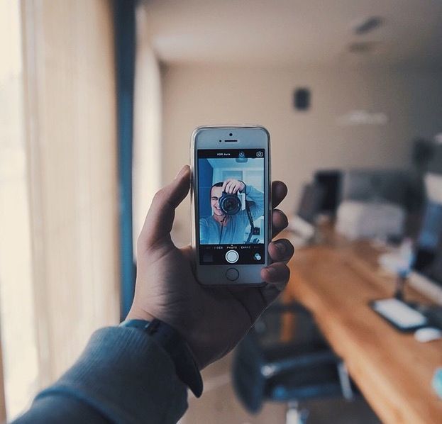 person, holding, part of, indoors, cropped, human finger, technology, lifestyles, photography themes, focus on foreground, personal perspective, leisure activity, men, unrecognizable person, communication, photographing, wireless technology