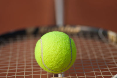 Close-up of tennis ball on racket