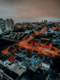 High angle view of illuminated buildings in city at sunset