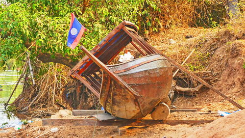 Abandoned boat on field