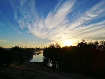 Scenic view of silhouette trees against sky during sunset