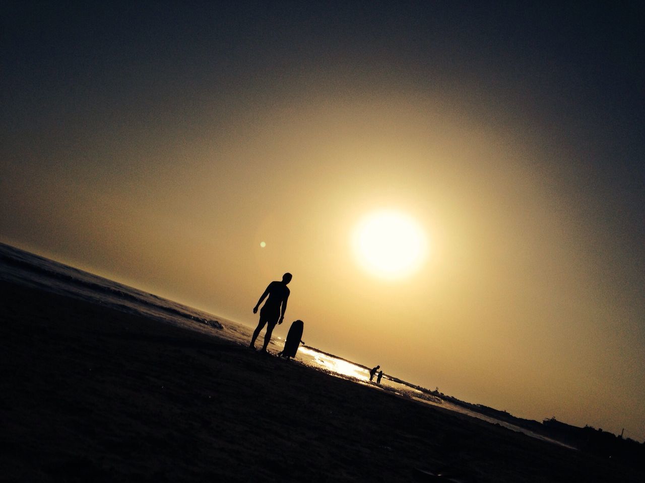 lifestyles, leisure activity, men, silhouette, sunset, sun, full length, beach, walking, sunlight, sea, sky, copy space, sand, togetherness, horizon over water, shore