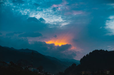 Scenic view of silhouette mountains against sky at sunset