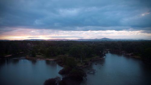 Scenic view of river against sky during sunset