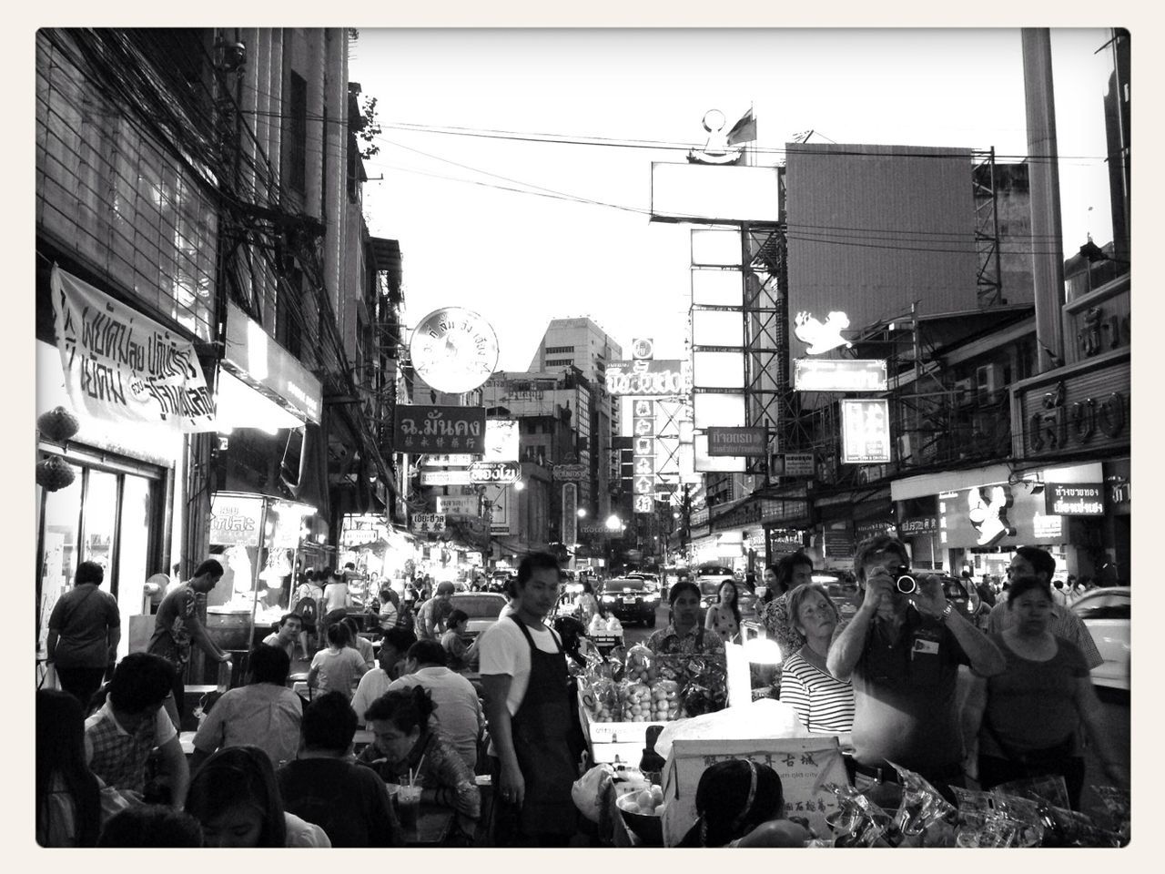 transfer print, large group of people, auto post production filter, building exterior, men, architecture, built structure, person, lifestyles, city, crowd, city life, clear sky, street, leisure activity, day, outdoors, mixed age range, building