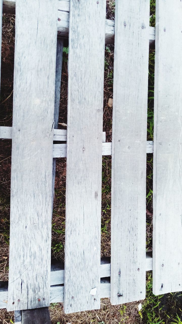 CLOSE-UP OF FENCE ON WHITE WALL
