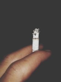 Human hand holding cigarette