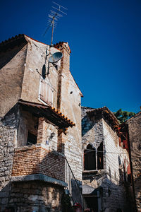 Low angle view of old building against clear blue sky