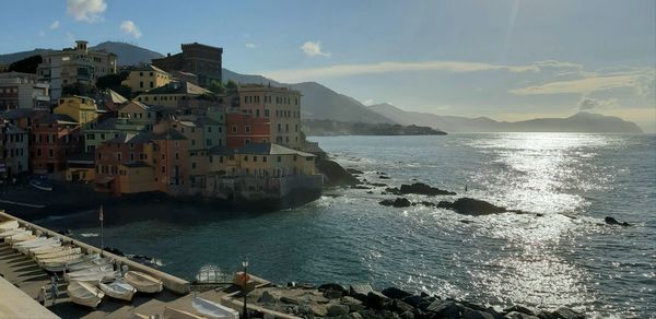 Panoramic view of sea and buildings against sky